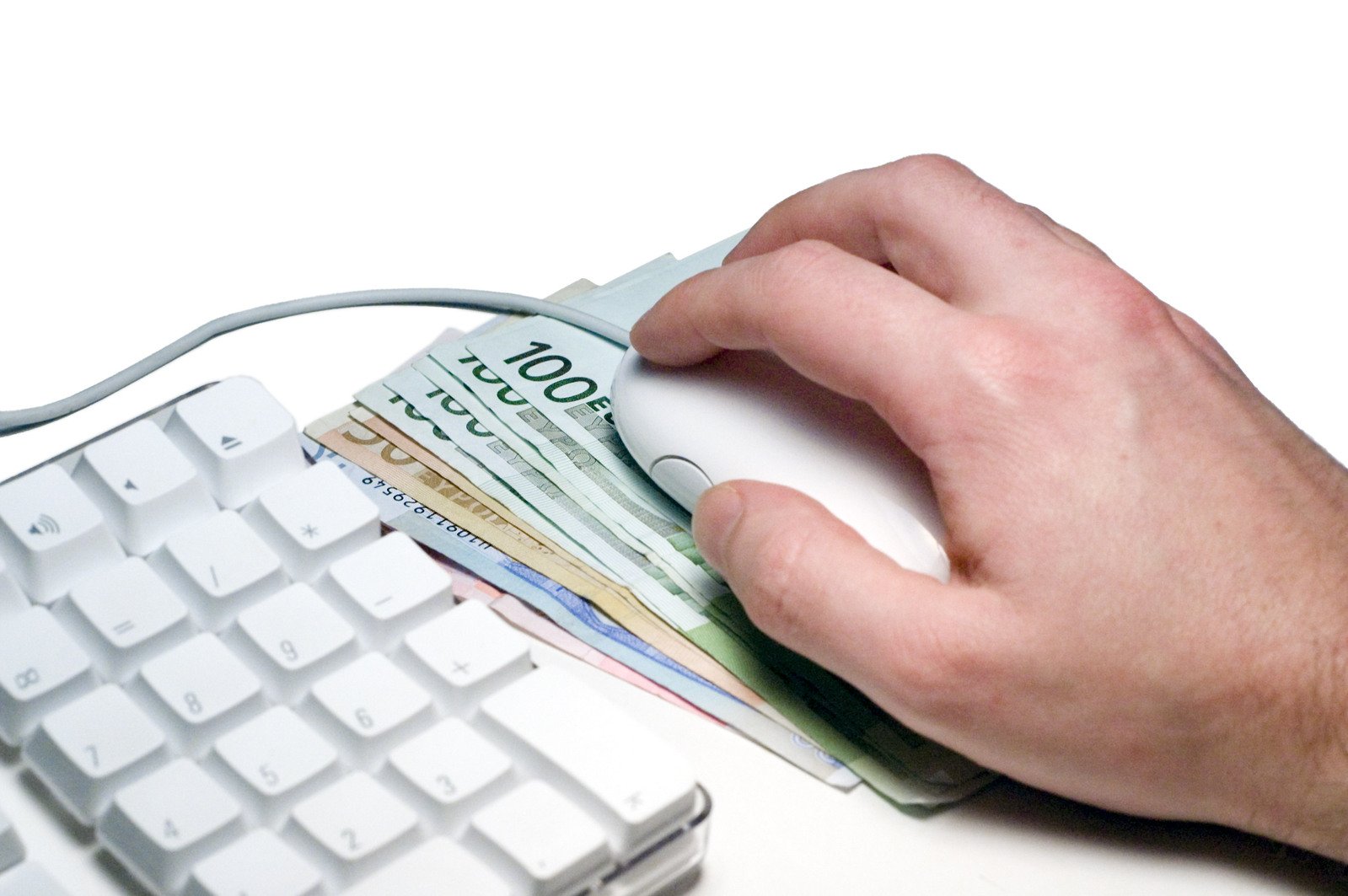 a hand is holding a few euros notes in front of a keyboard