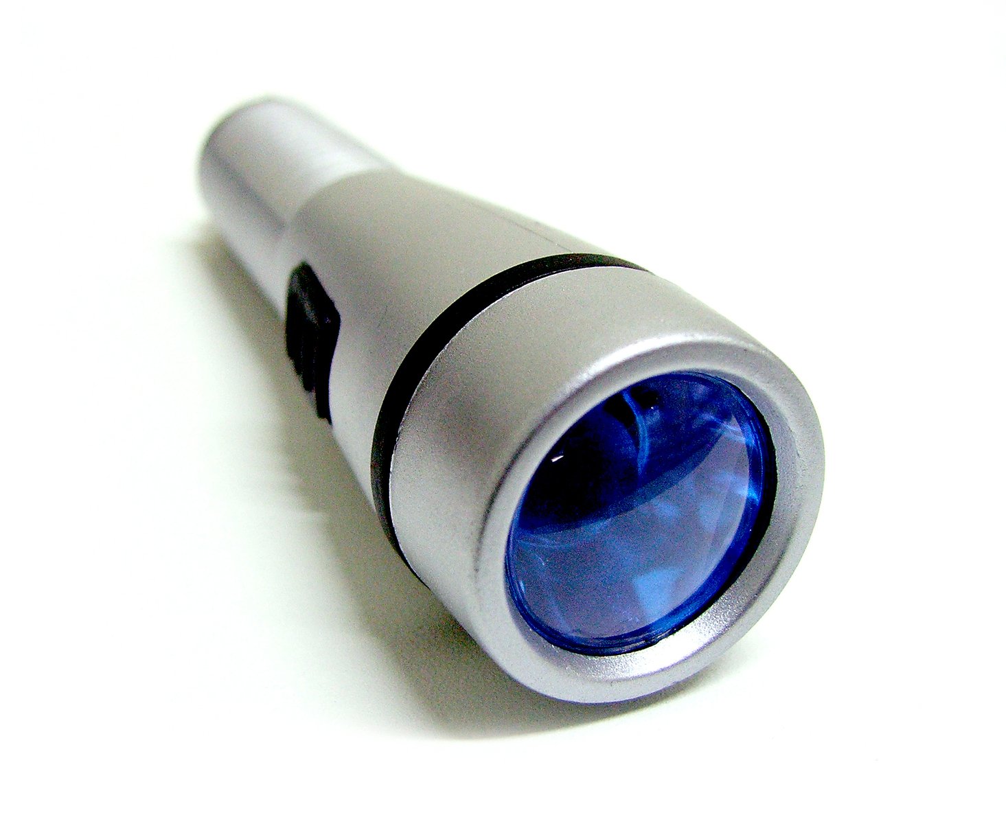 a close up of a flashlight on a white surface