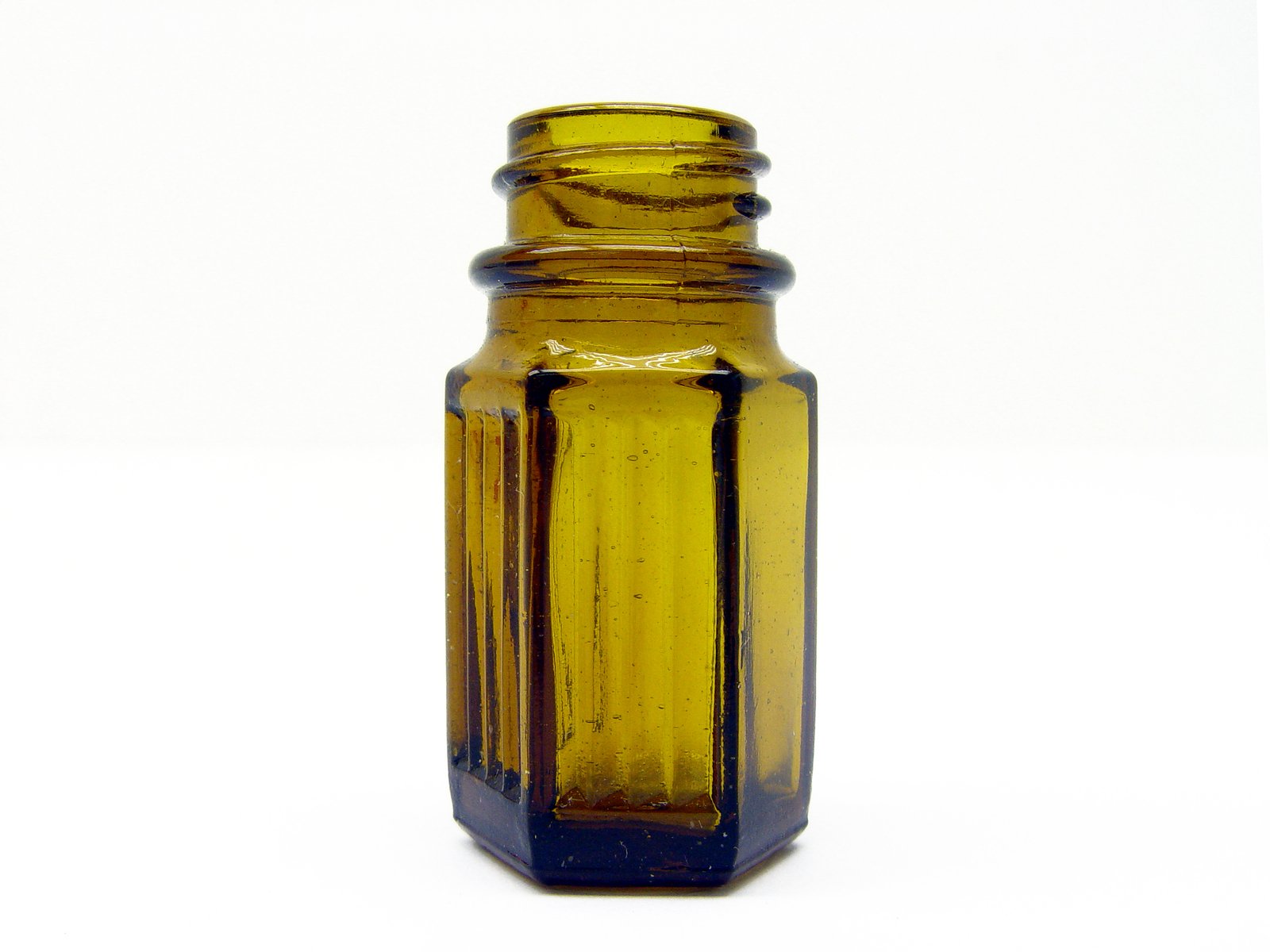 brown glass bottle with gold trim on a white background