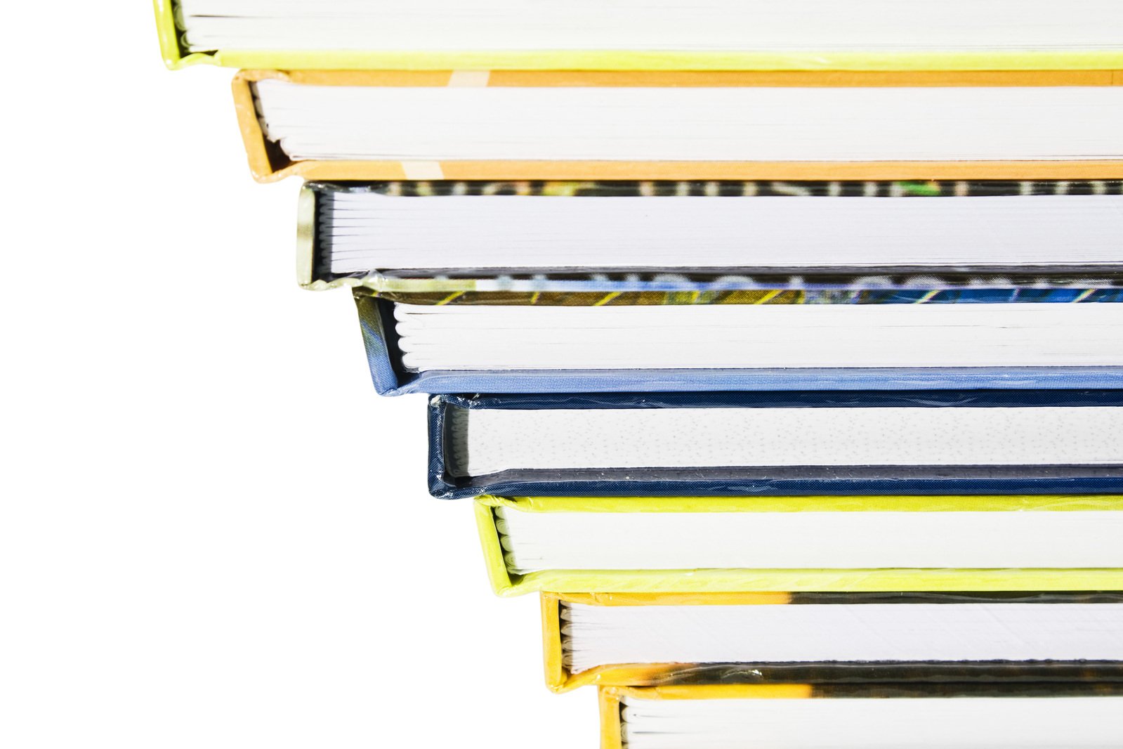 a stack of open books with one bookmark in the middle