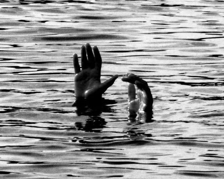 two hands touching each other in the water