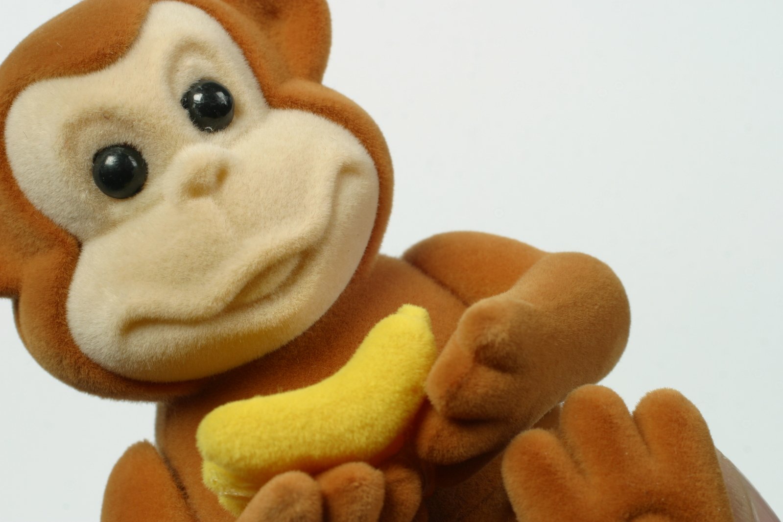 a stuffed monkey with a banana in it's hand