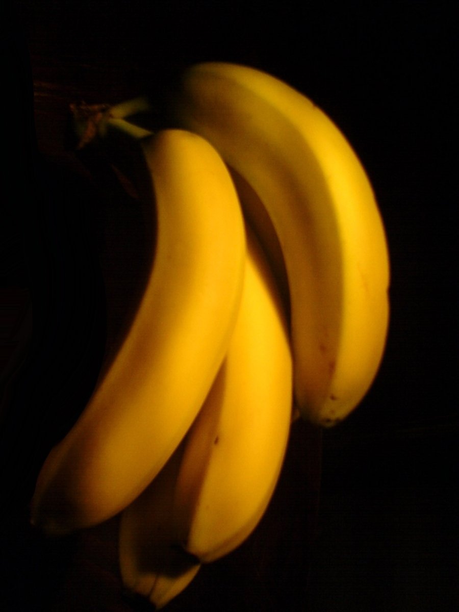 ripe yellow bananas sitting on top of a table