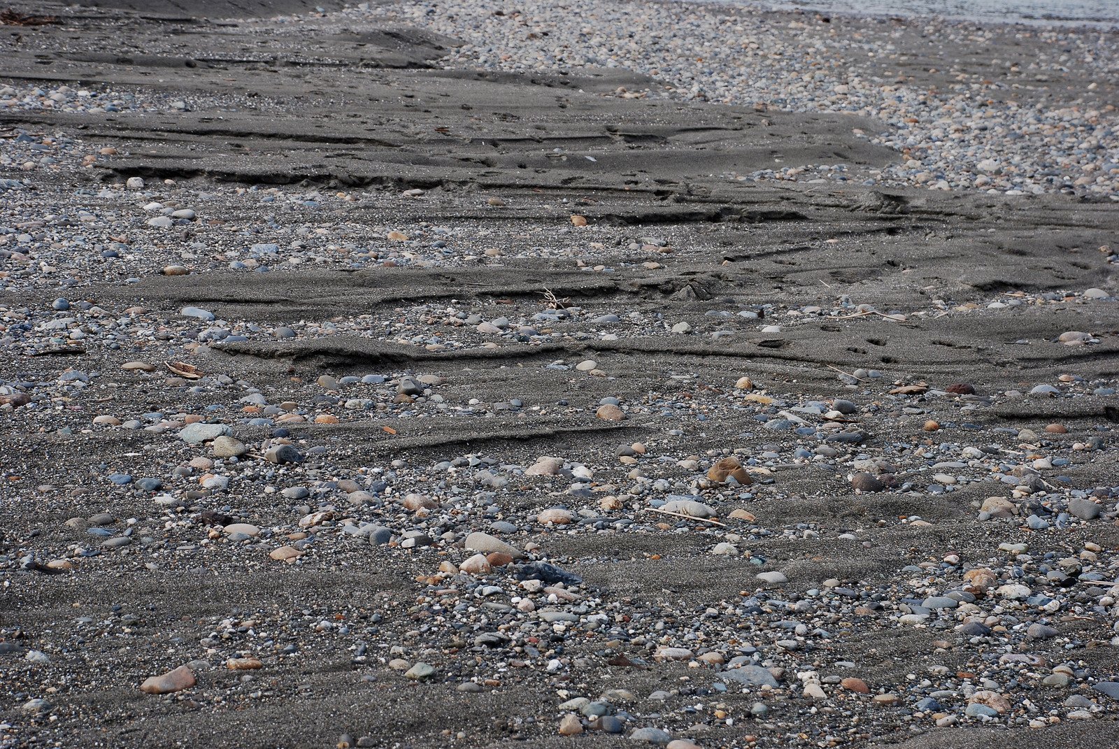 a sandy beach has an extremely steep and sandy path