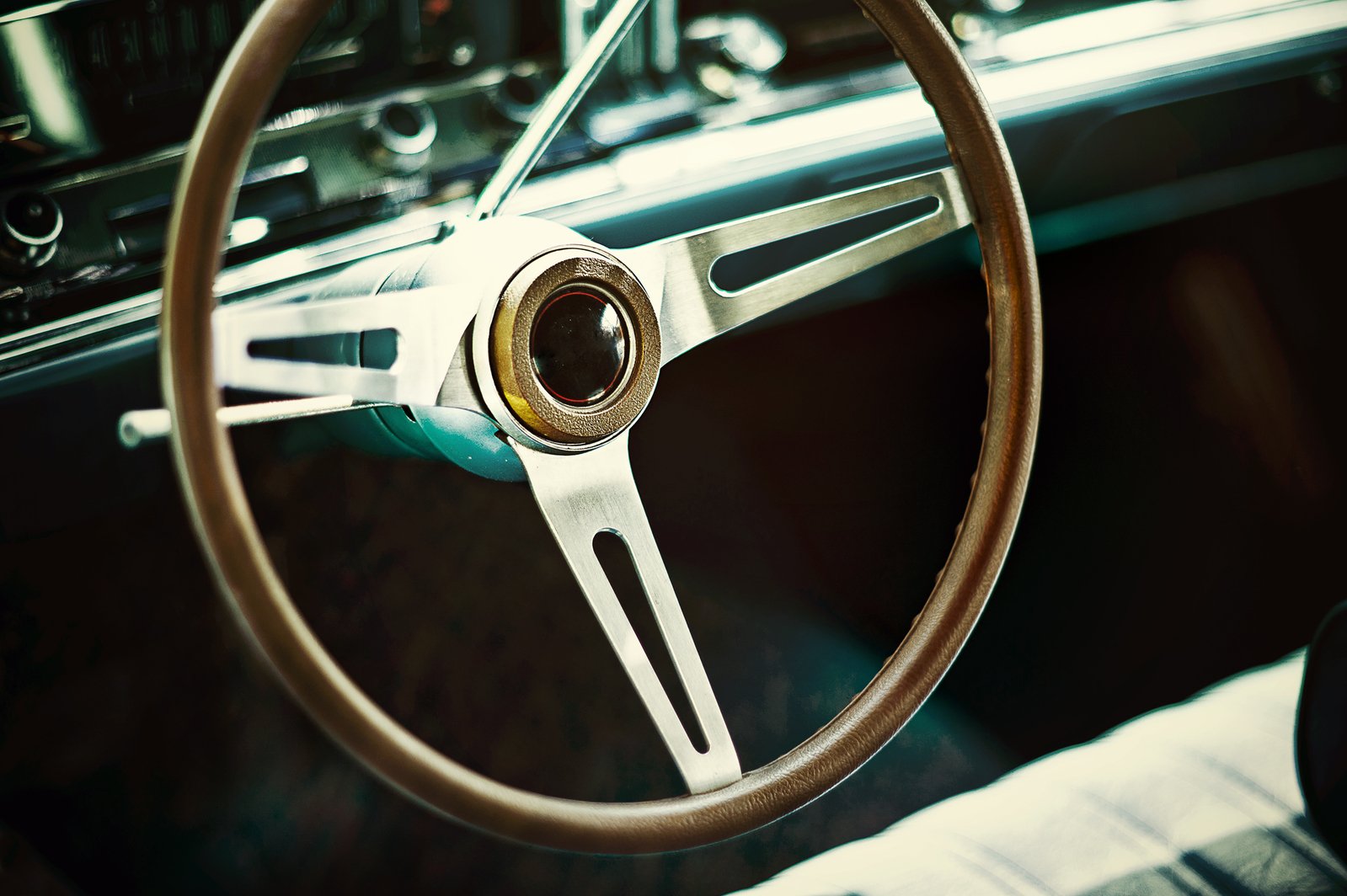 a wheel is on a car's dashboard and there is only a stitched steering wheel