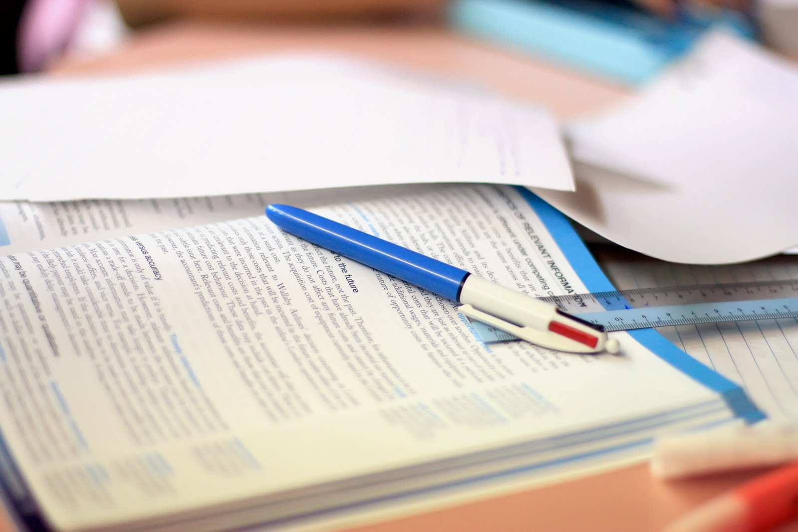 a pen sits on an open book that has been folded open