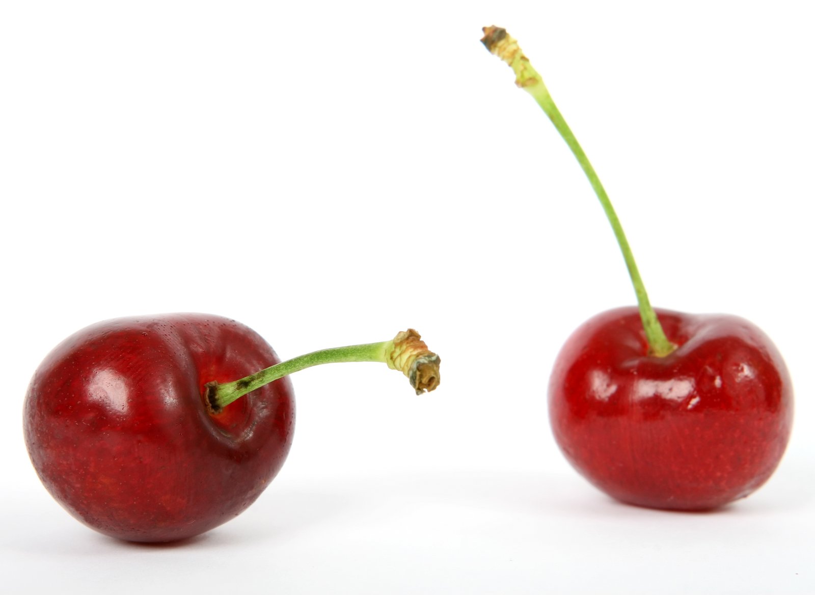 two cherries are facing each other in the same direction