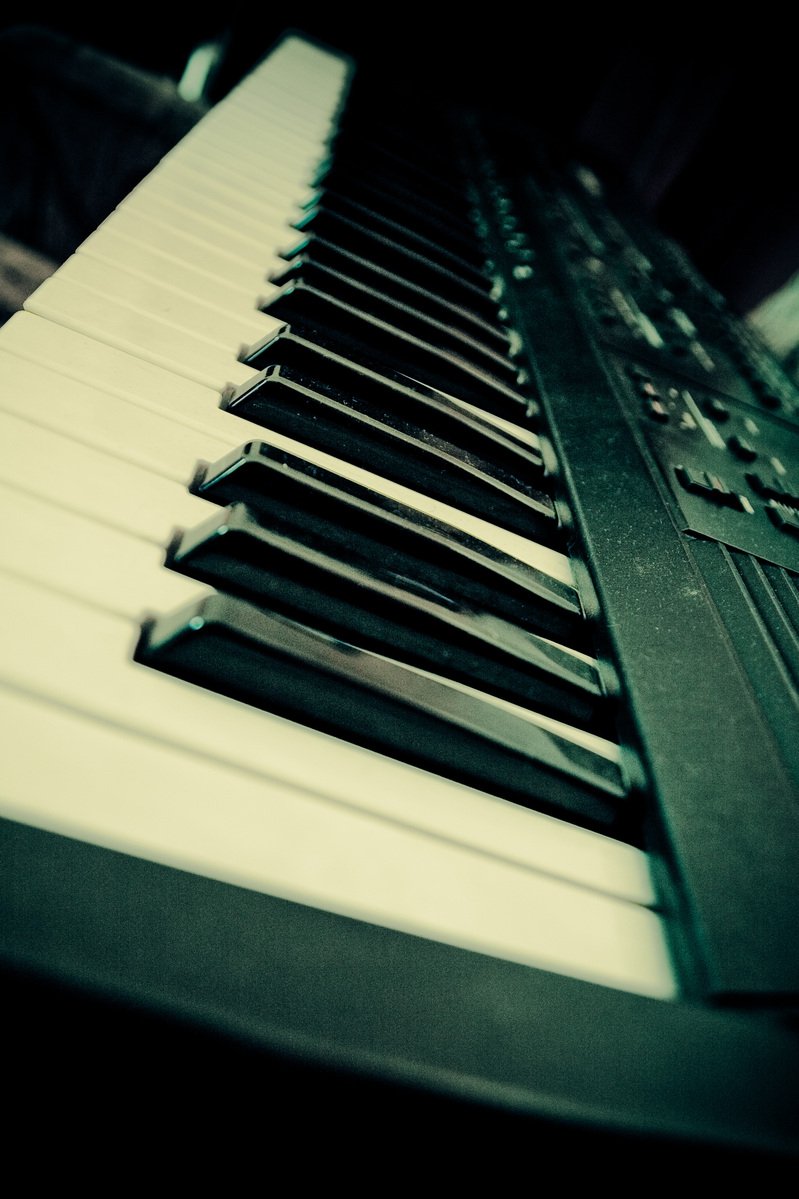 a close up of a piano keyboard's keys and the musical tab