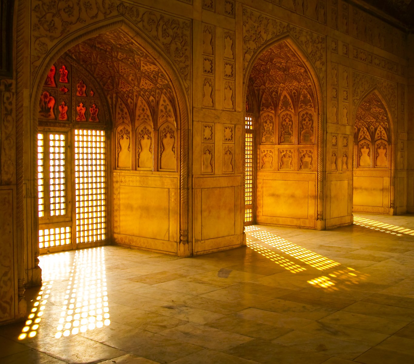 sunlight streaming through window into a large, intricate building