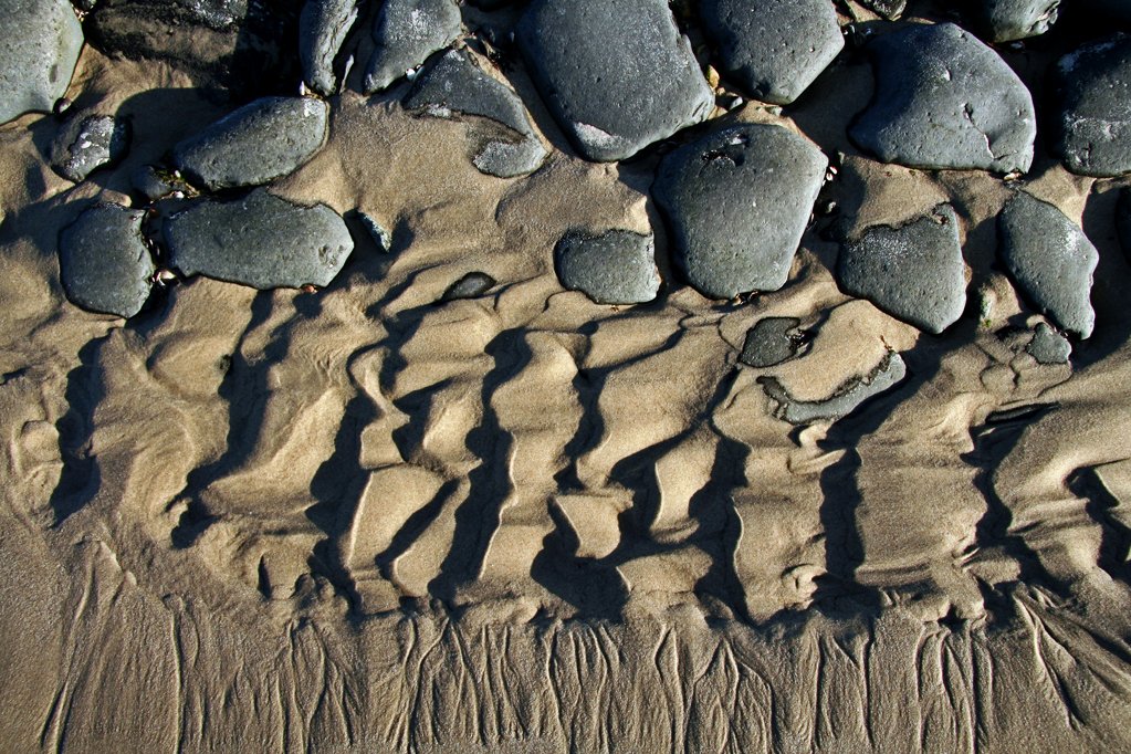 a sandy area with rocks and sand