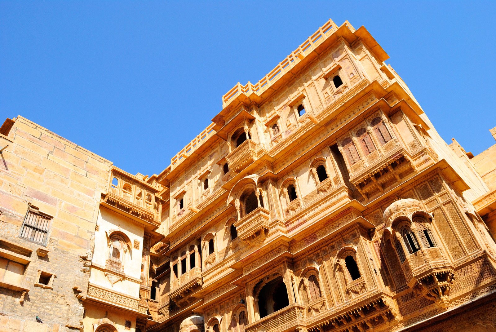 a very tall stone building with lots of windows