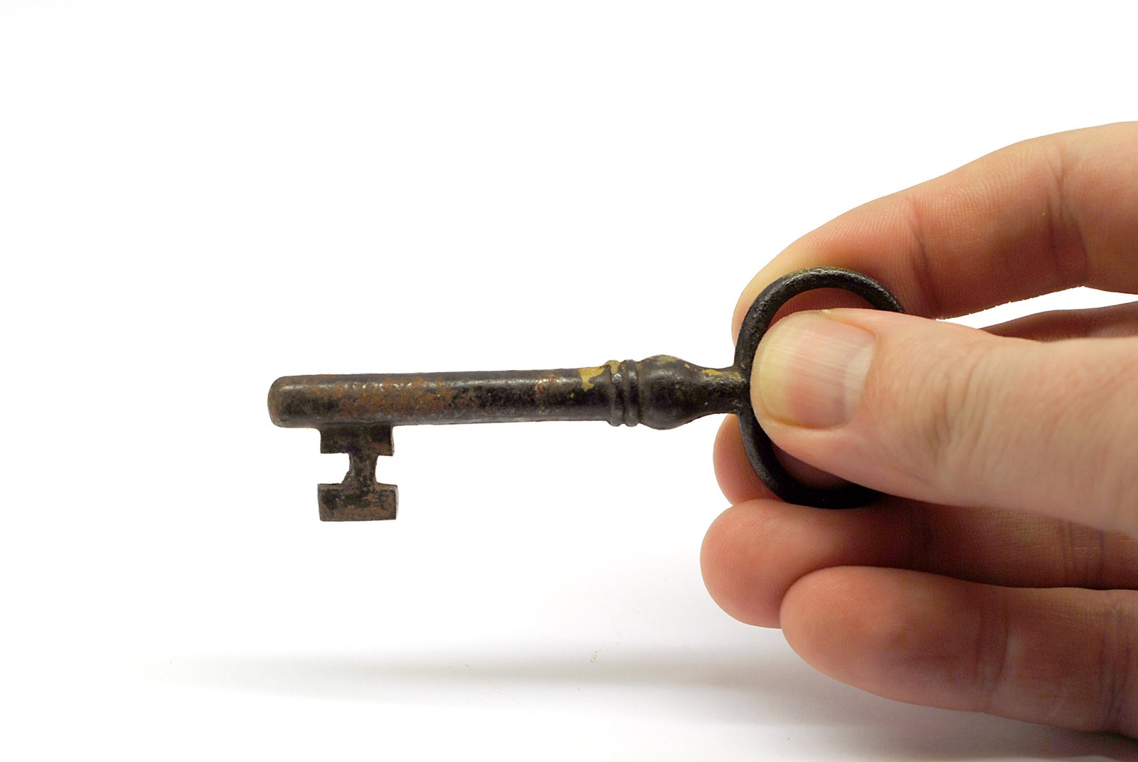 someone is holding a tiny old keys in their hand