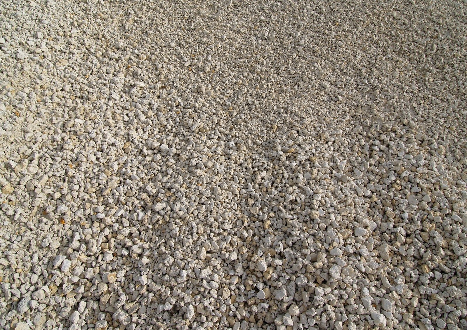 there is a yellow stop sign with stones at the bottom