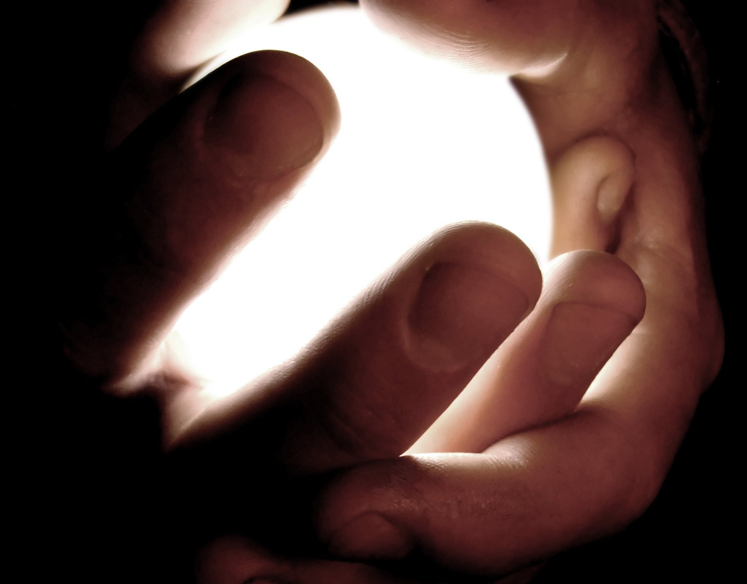 light being projected from an open hand that shows the light