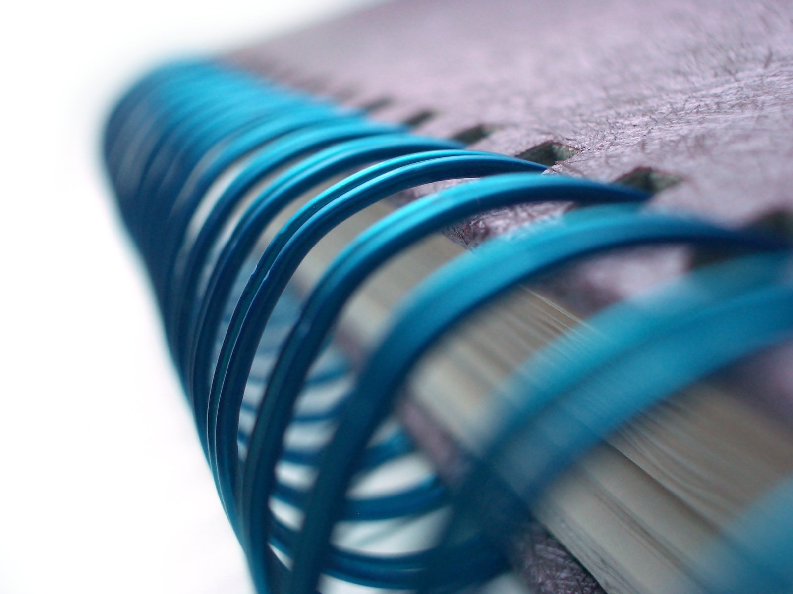 several blue wire hang from the top of a bookshelf