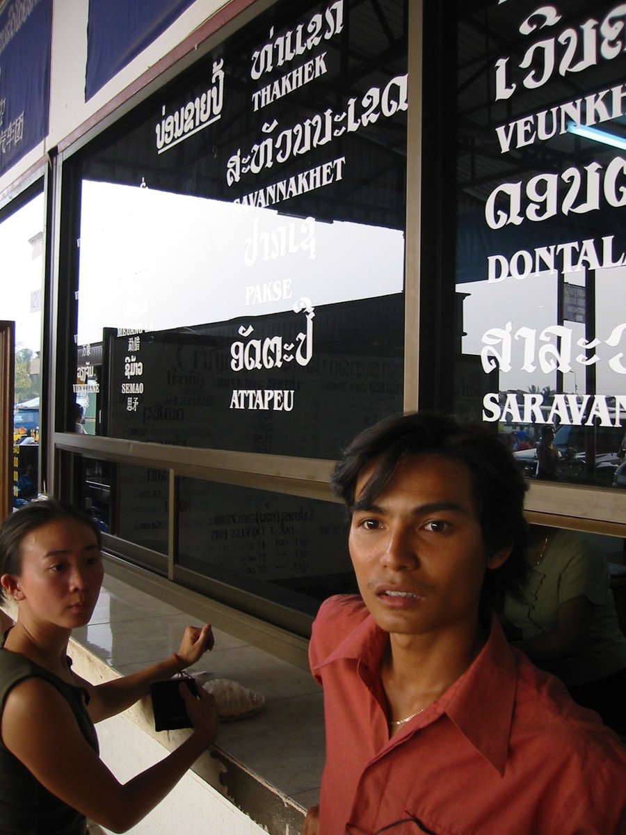 two people standing behind a window by itself