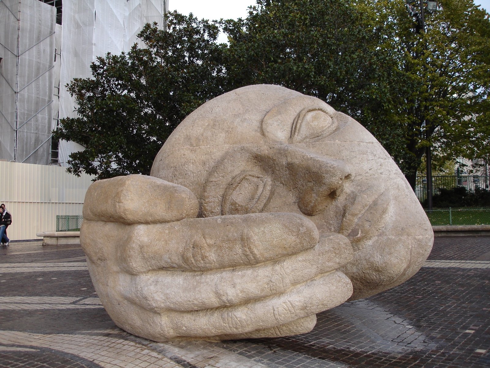 a sculpture of a person resting against it