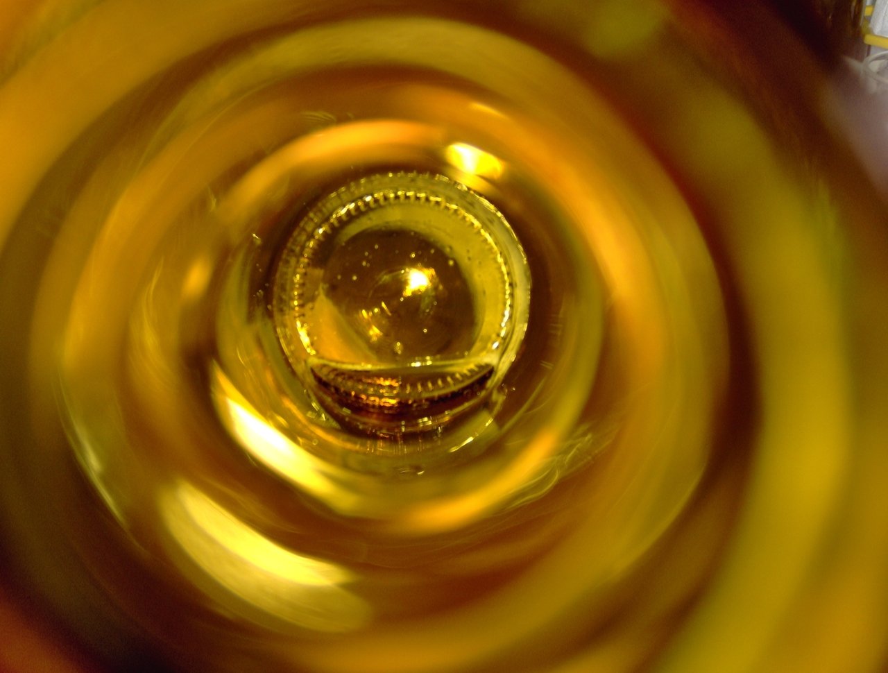 the view from inside a yellow wine bottle