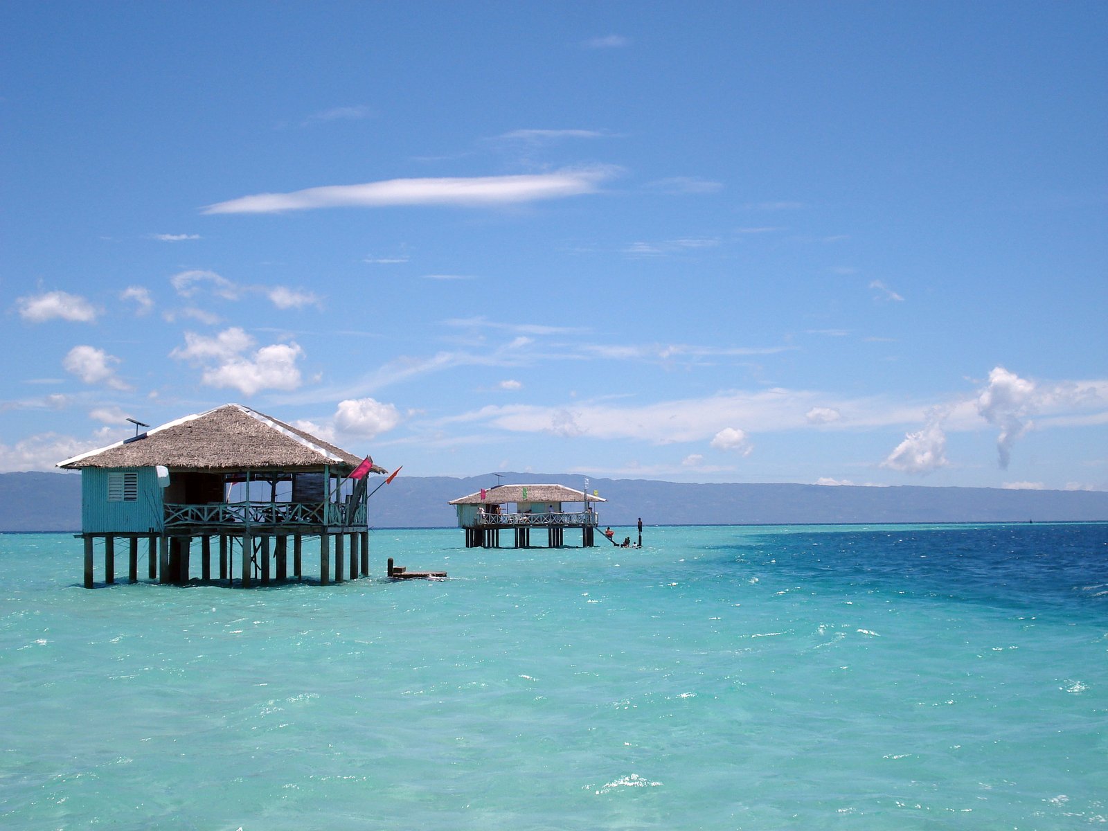 a body of water with a small wooden pier