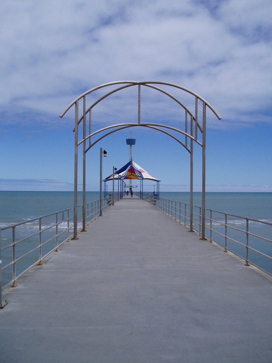 a pier with some people on it and the water around