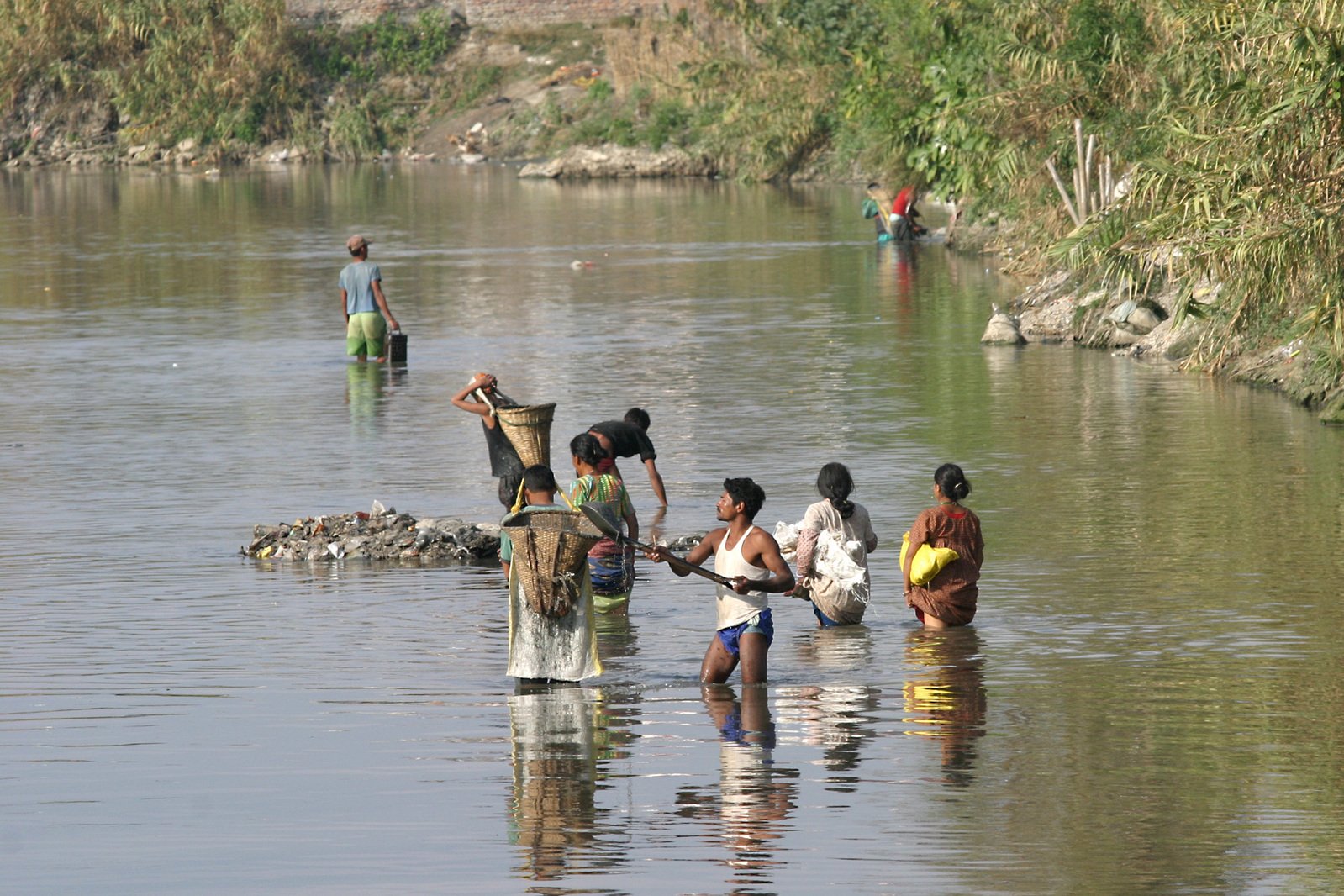 several people are bathing in the river