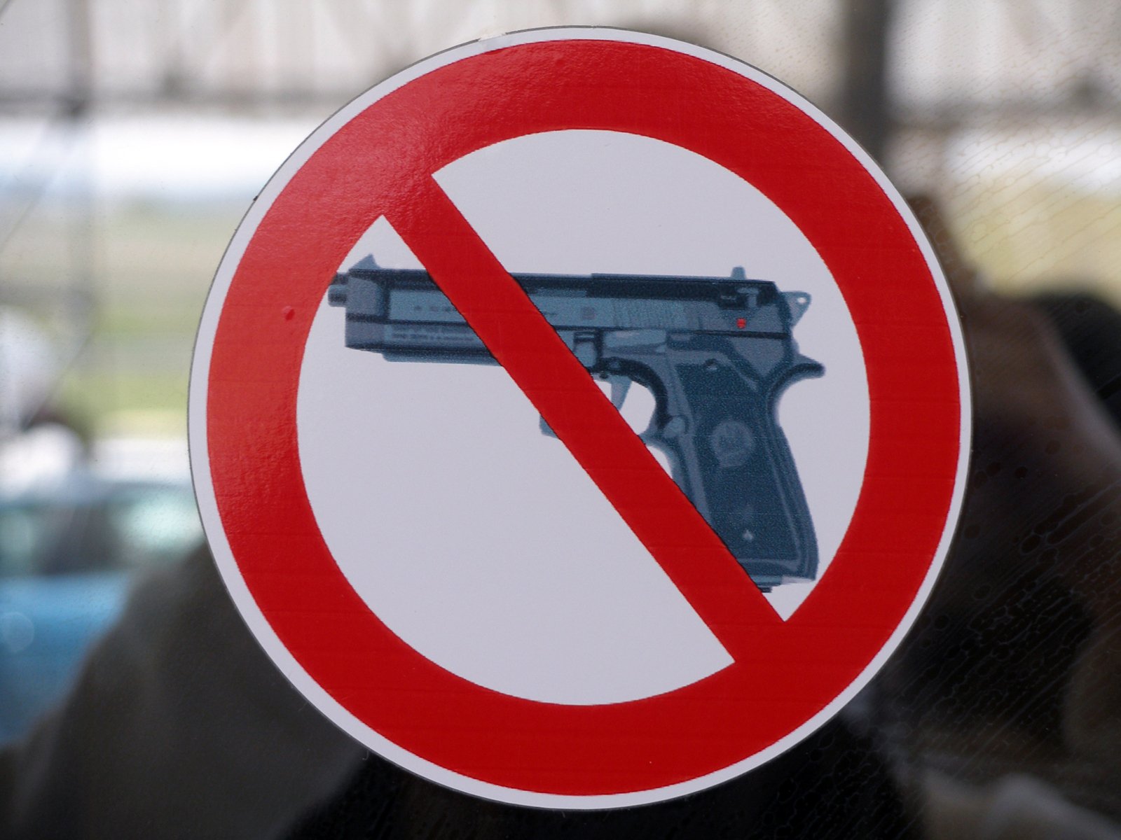 a no gun sign with a po of a gun