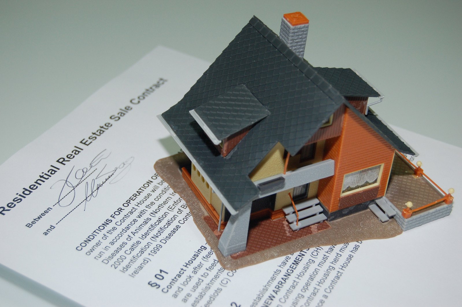 a model house sitting on top of a legal document