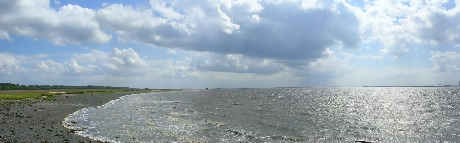 a body of water next to a sandy beach