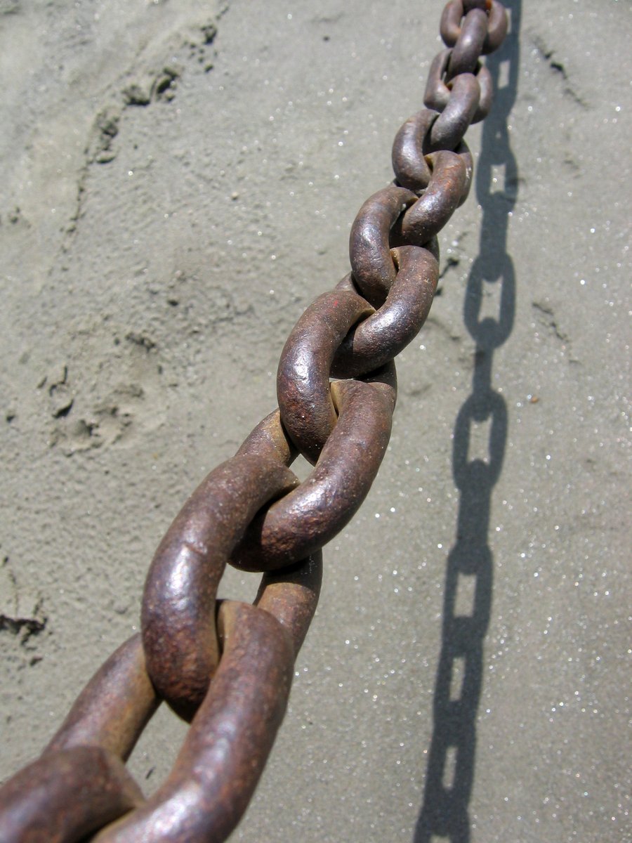 a long, rusty chain is attached to the concrete