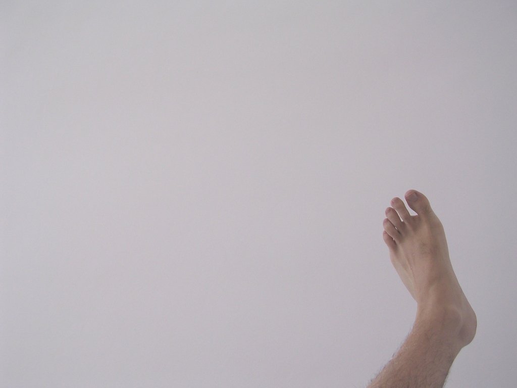 the feet of a man in a gray sky