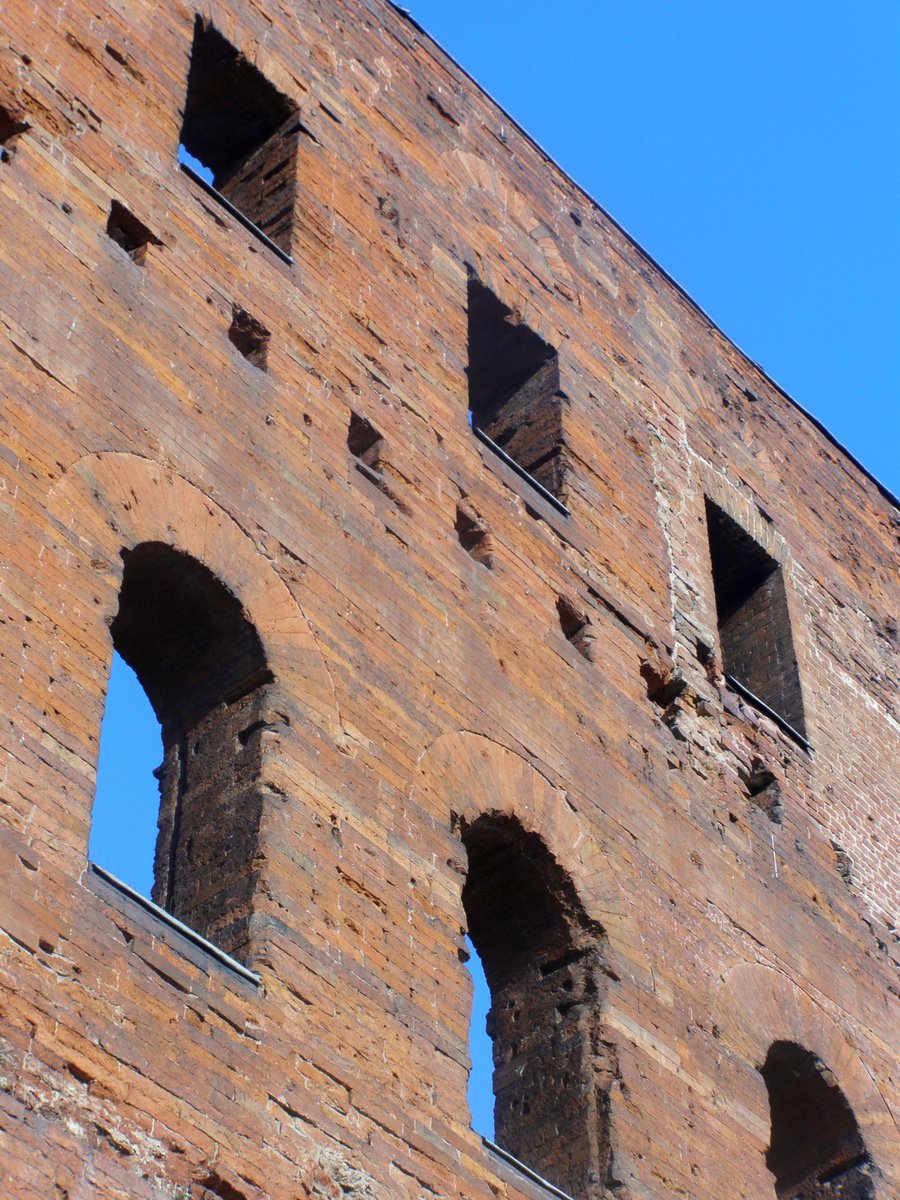 a close up of windows in an old brick building