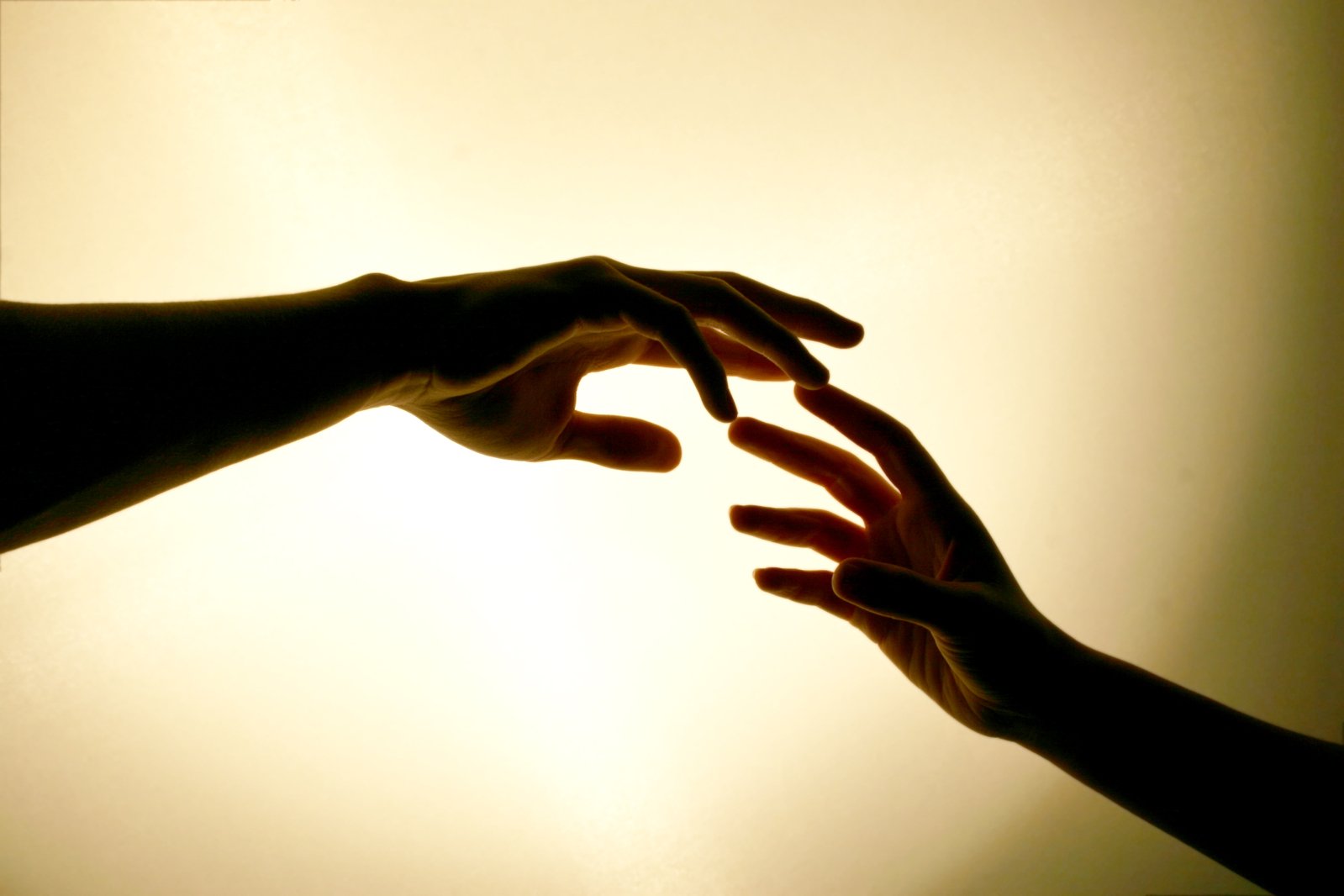 two people reaching out their arms towards each other