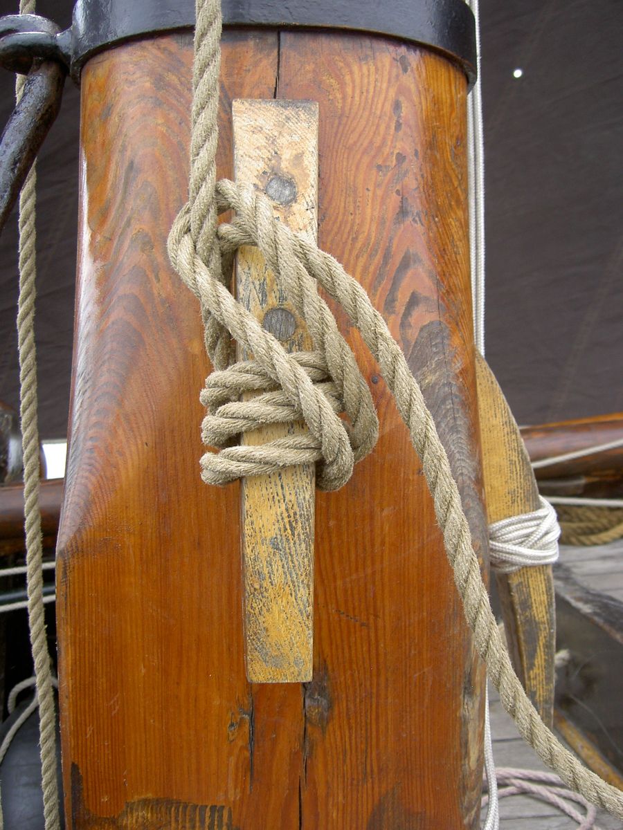 an image of rope and wooden boat mast