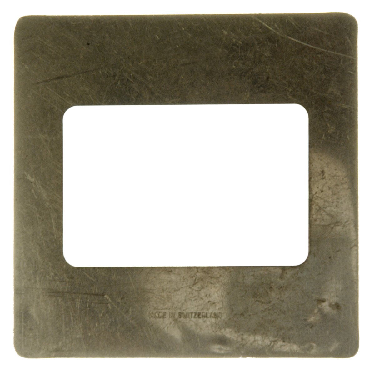 a silver metal square plate that has a white rectangular in the middle