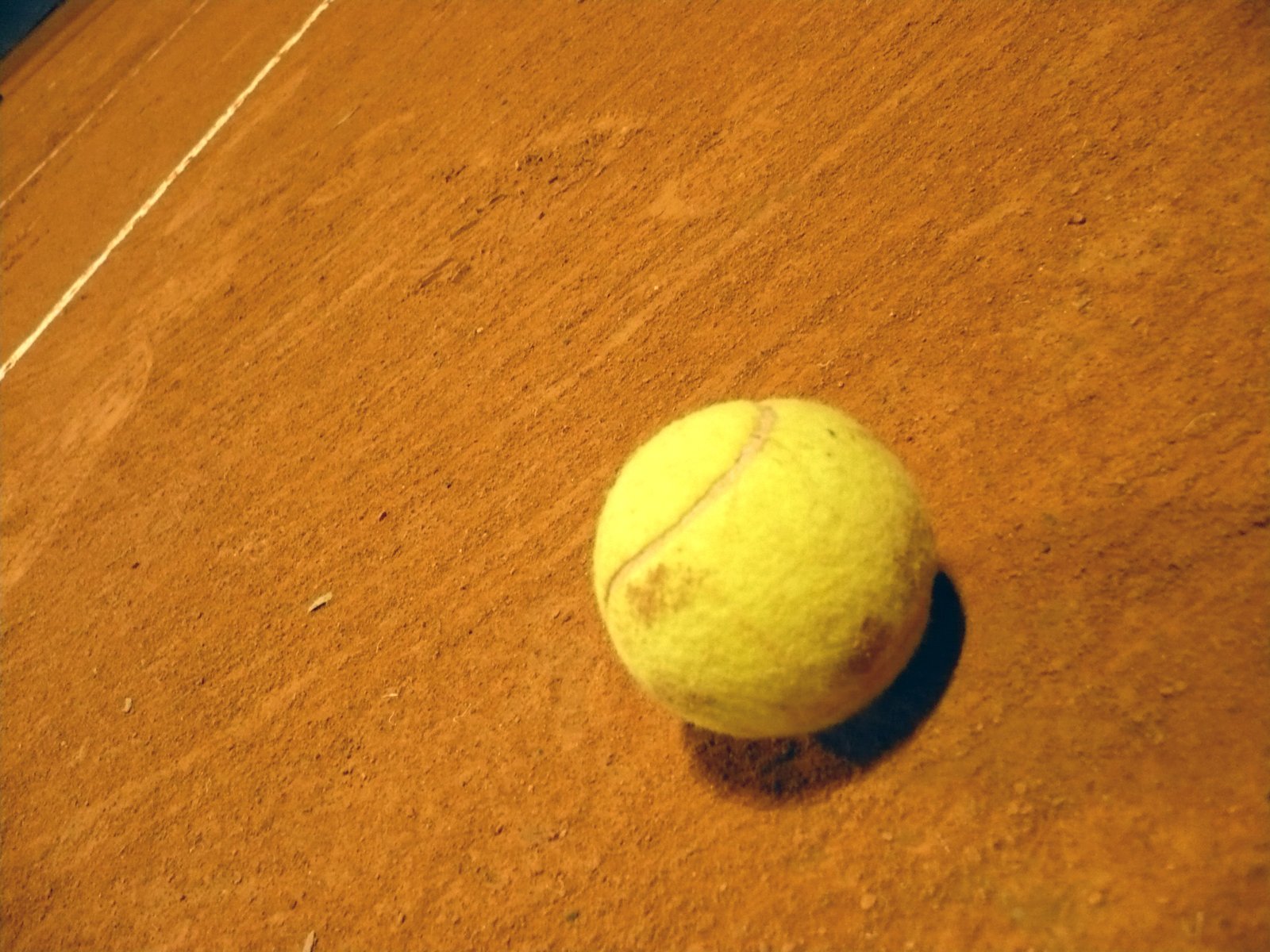 a close up of a tennis ball on a court