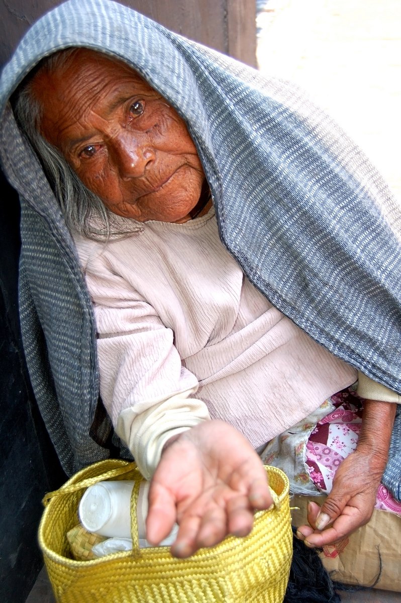 a woman sitting in a chair with a jar on it