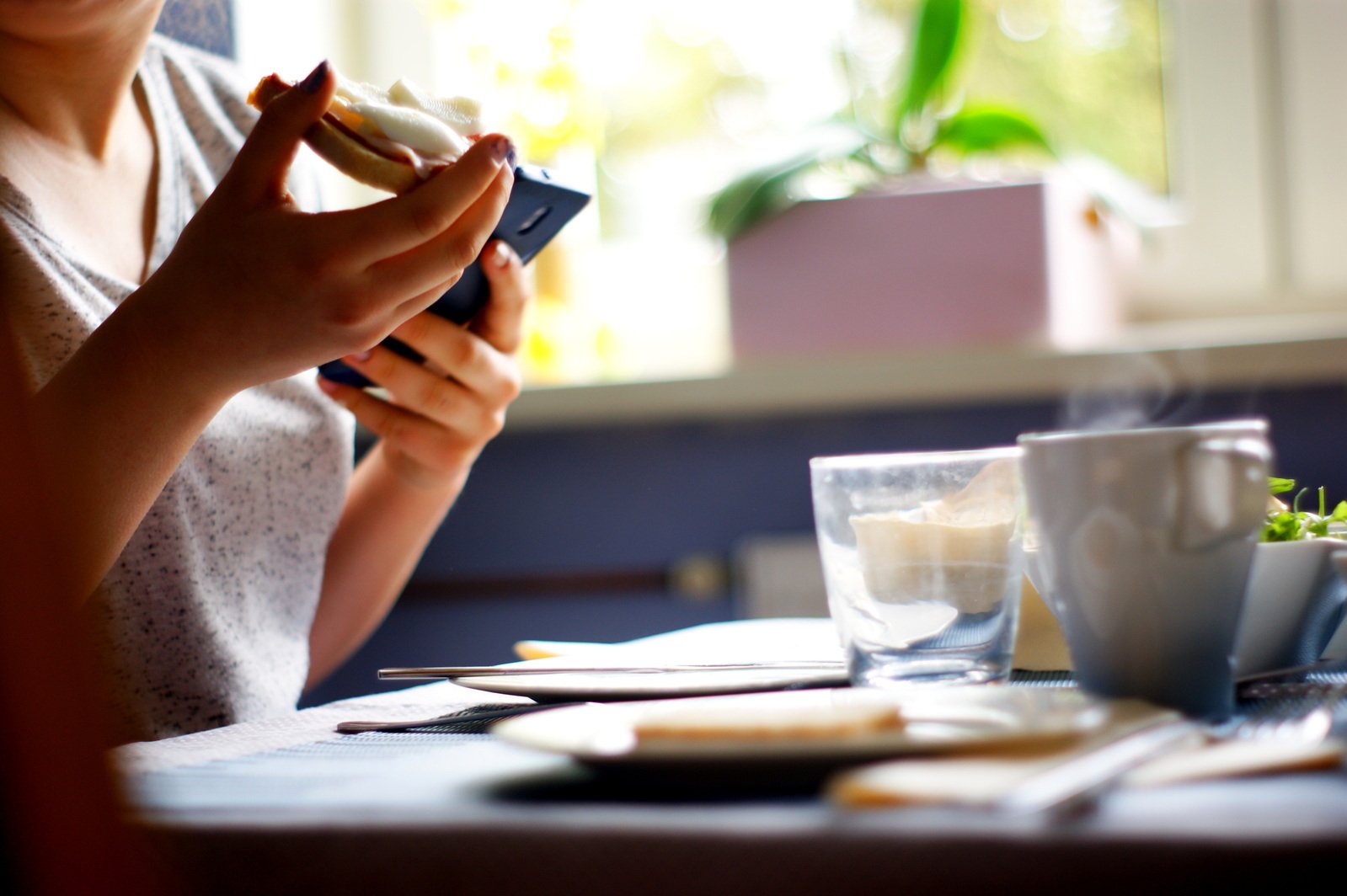 a person sitting at a table eating food