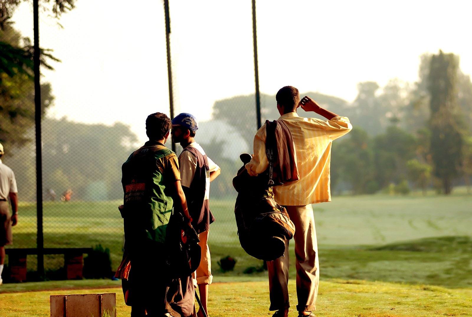 people walking away with a yellow blanket on their back