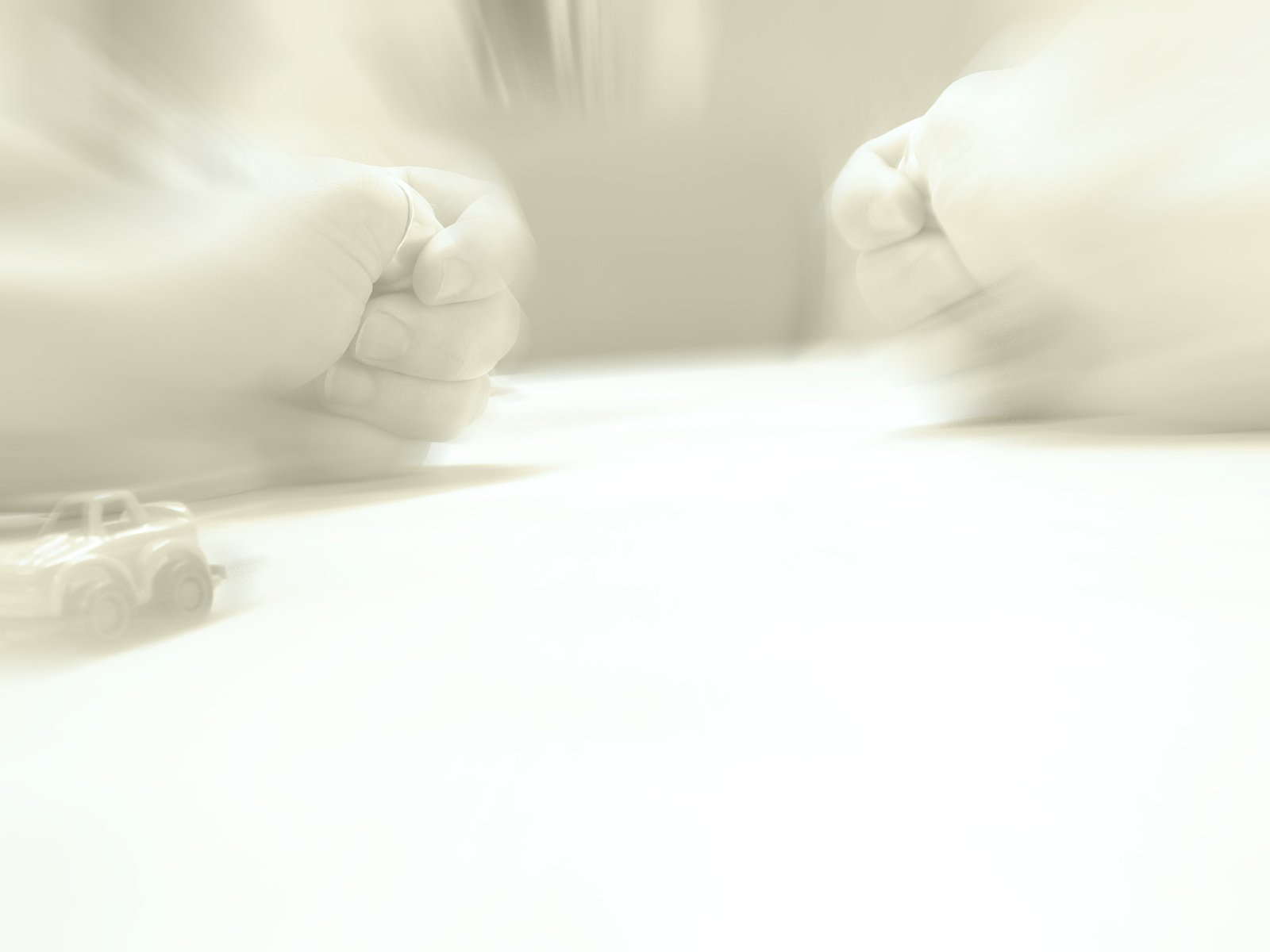 a blurry image of a desk with a white sheet and a toy car