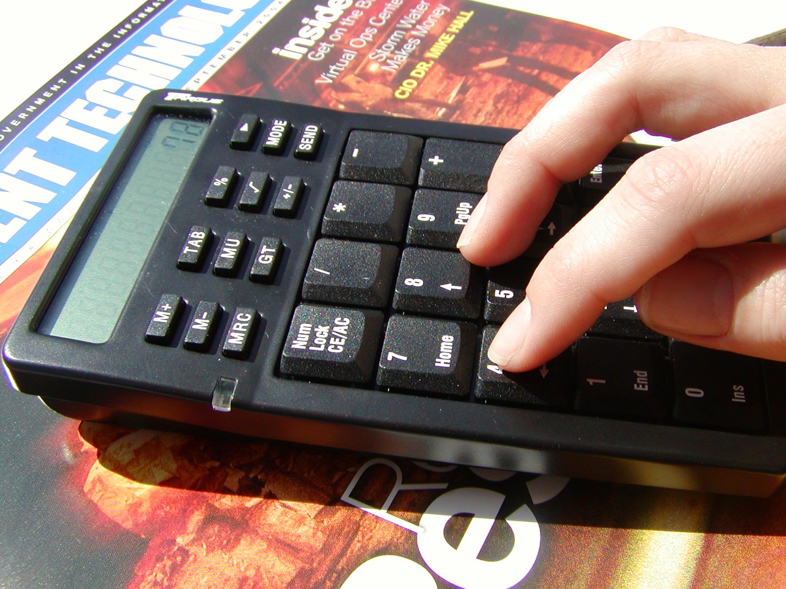 a persons hand is on the keys of a computer