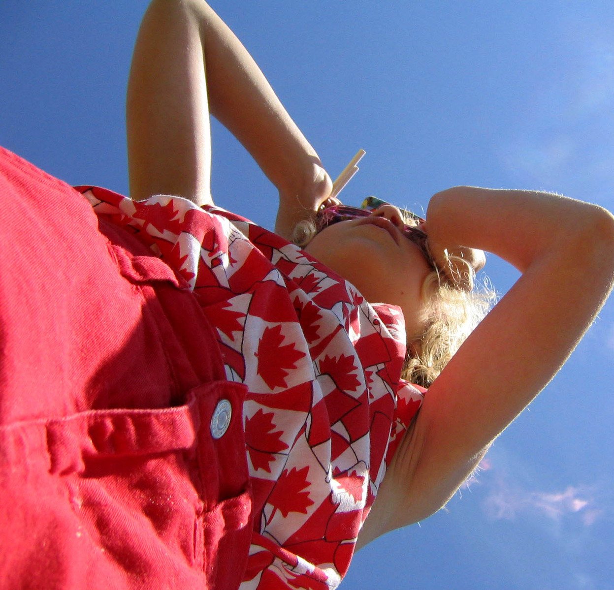 a young woman in a canadian flag shirt on the top of her head