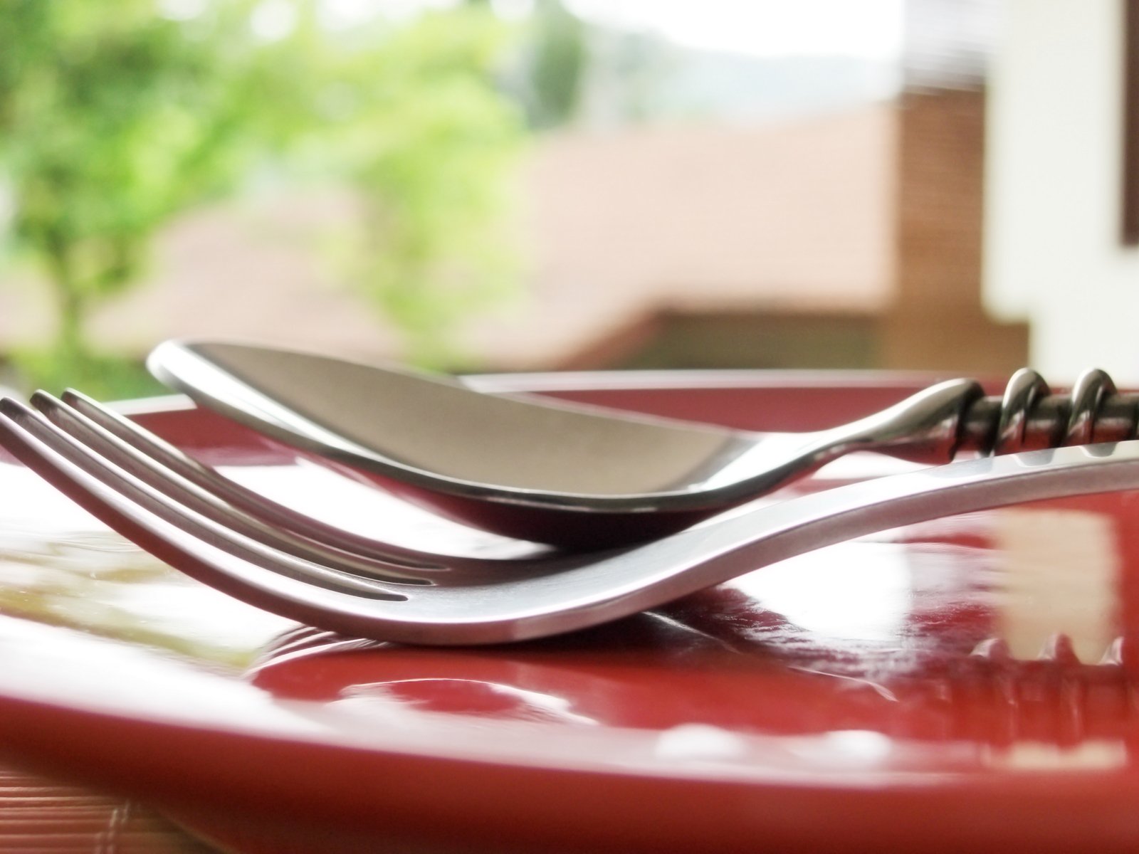 three forks and two spoons are on a table