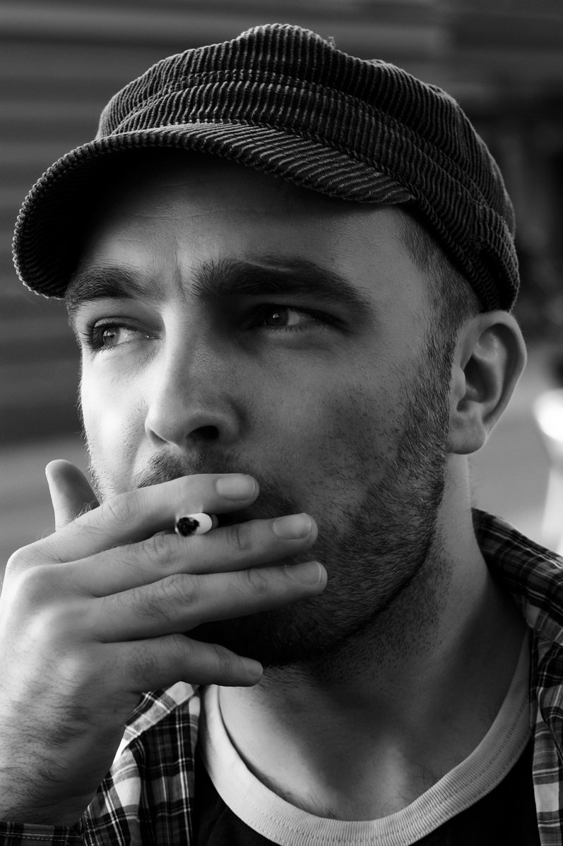 a black and white po of a young man smoking