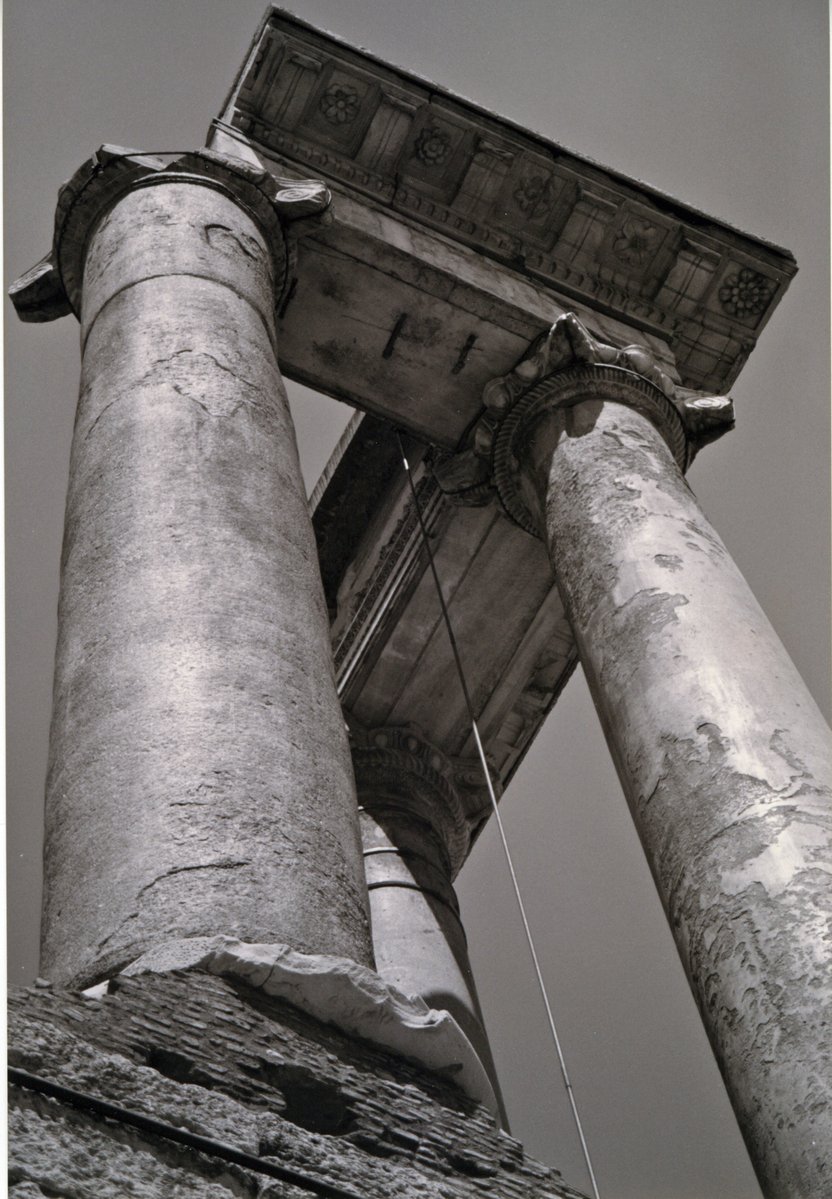 the columns of an old building have wooden frames