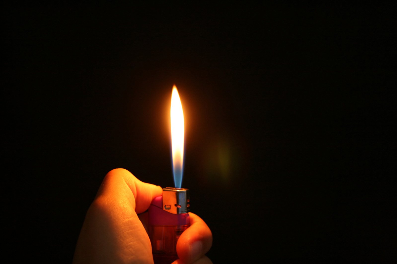a person holds a lighter up to the camera