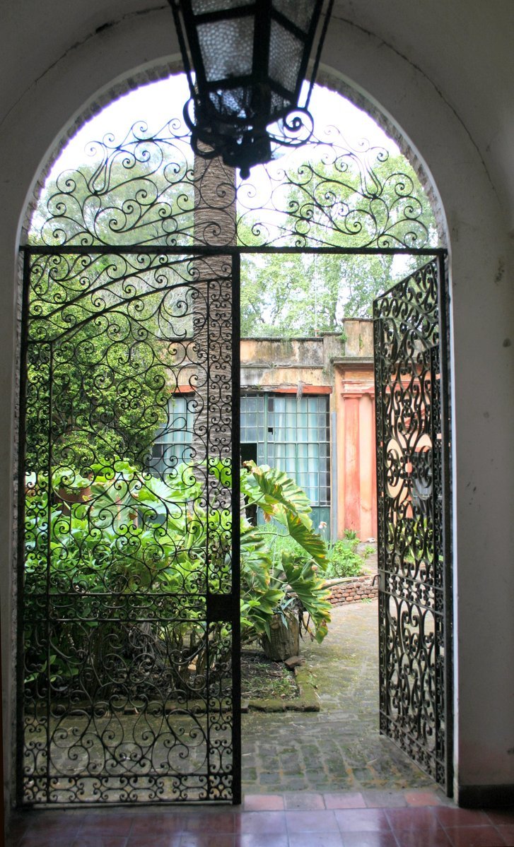 a large open gate with an iron door