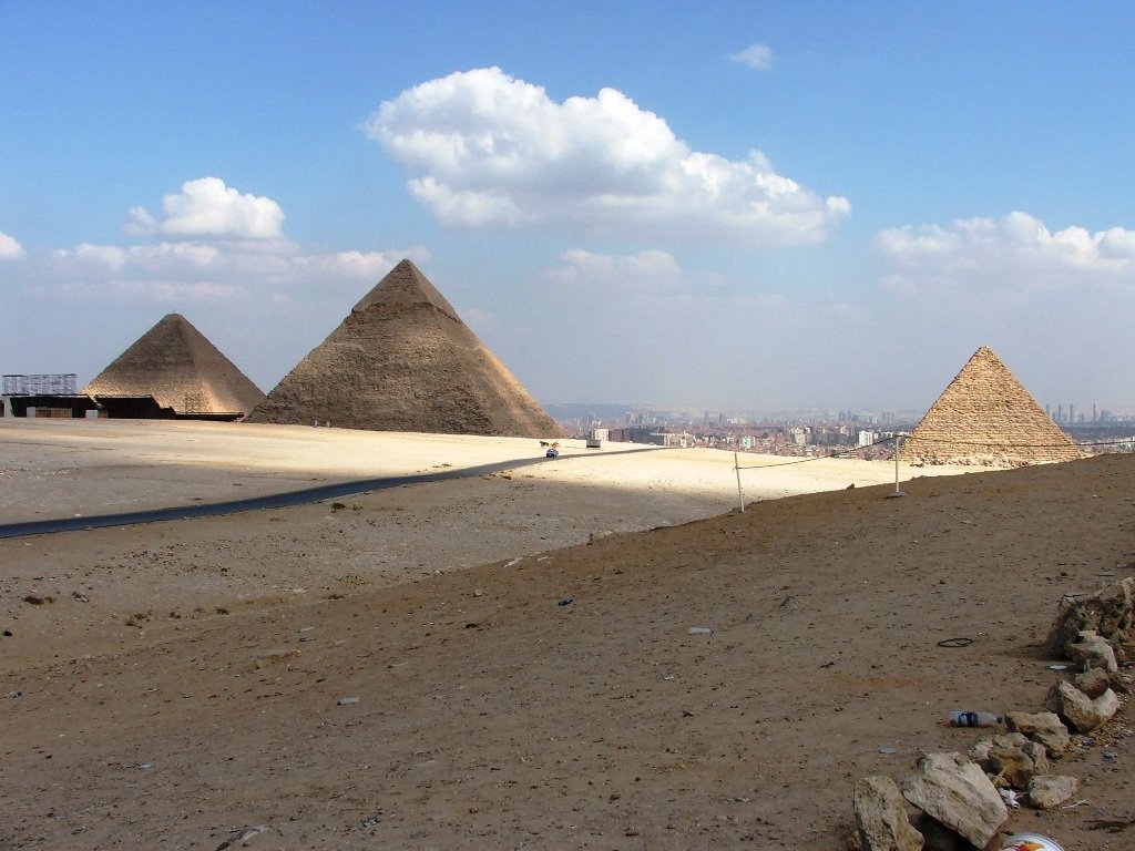 there are two egyptian pyramids next to a desert