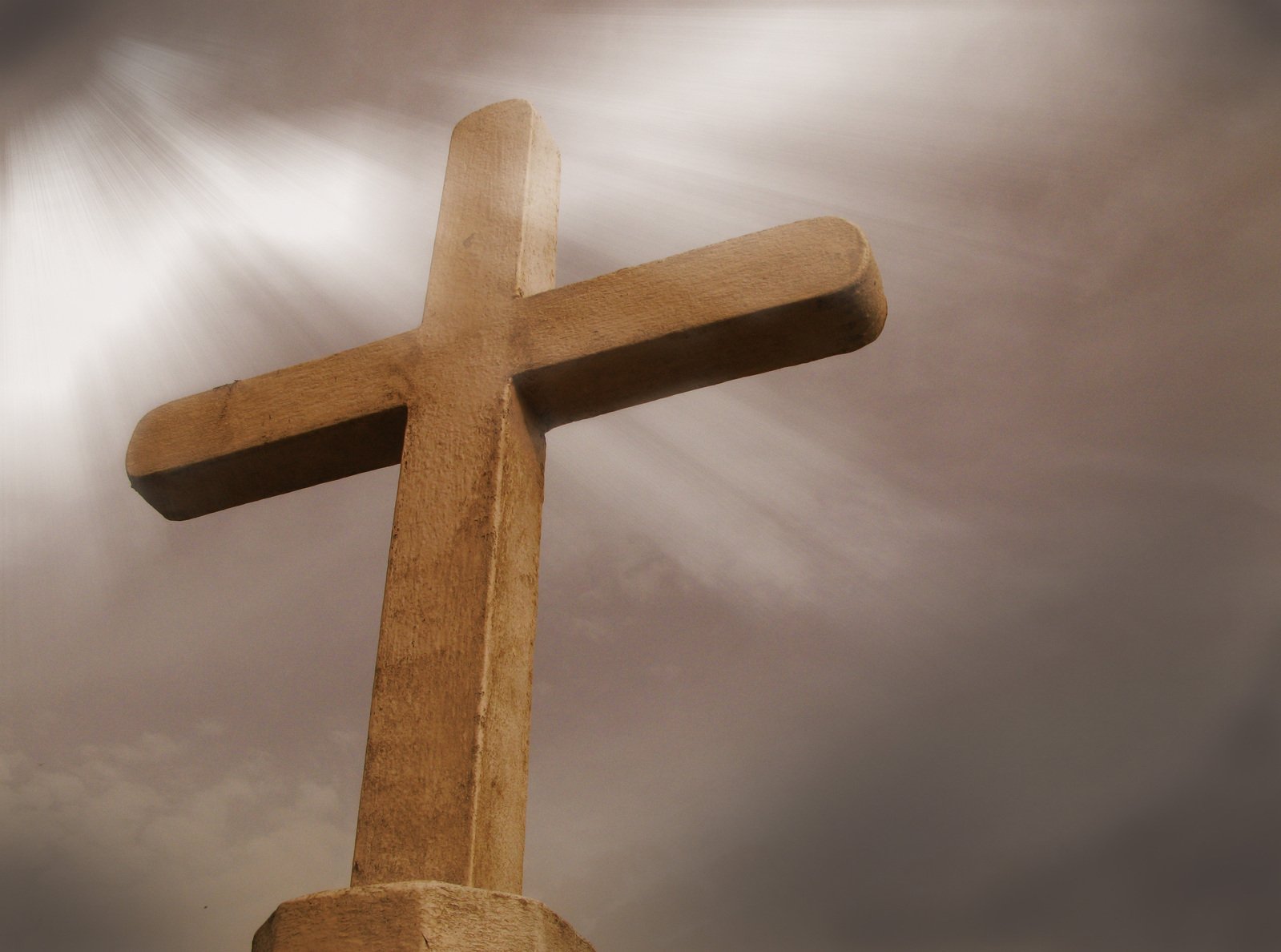 the cross on a pedestal is bathed in light