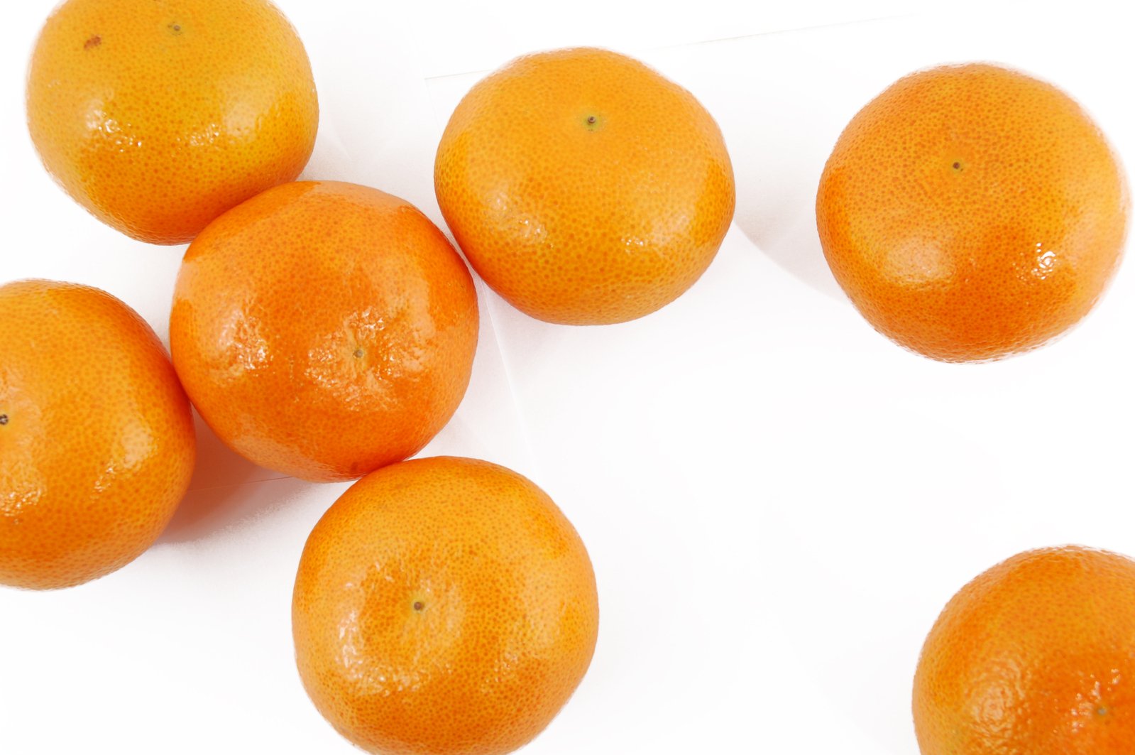 several oranges are arranged on the top of a table