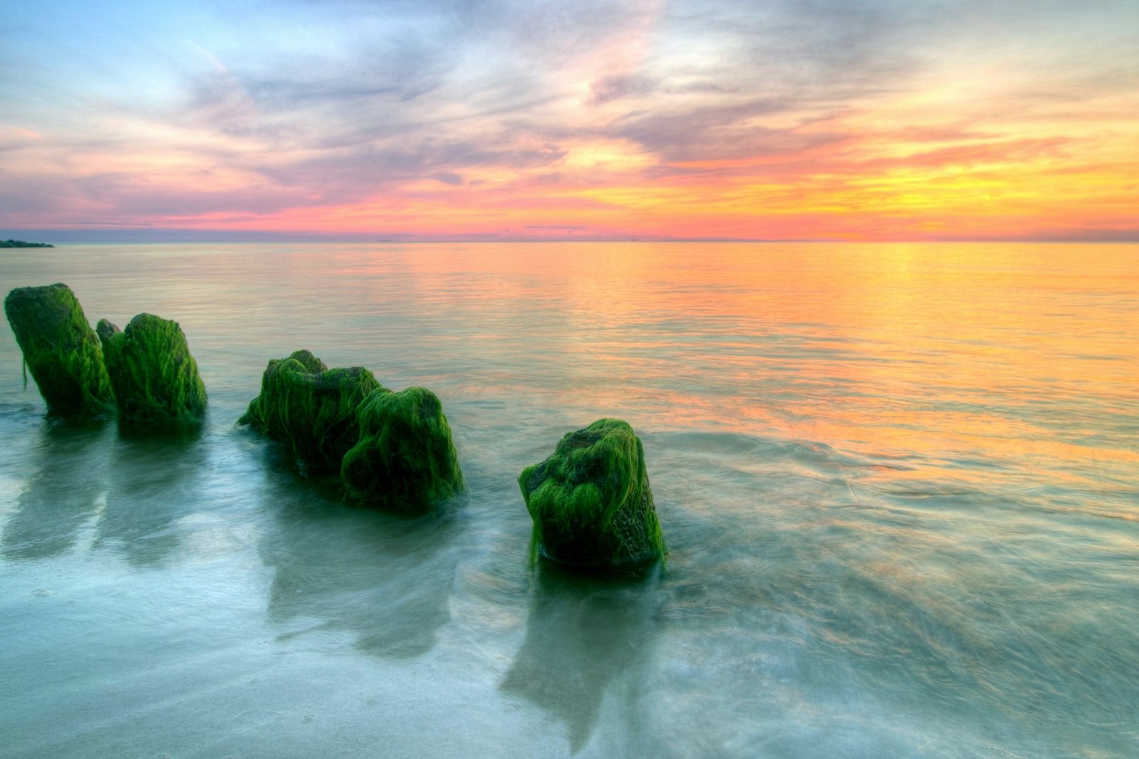 some rocks in the ocean near the water